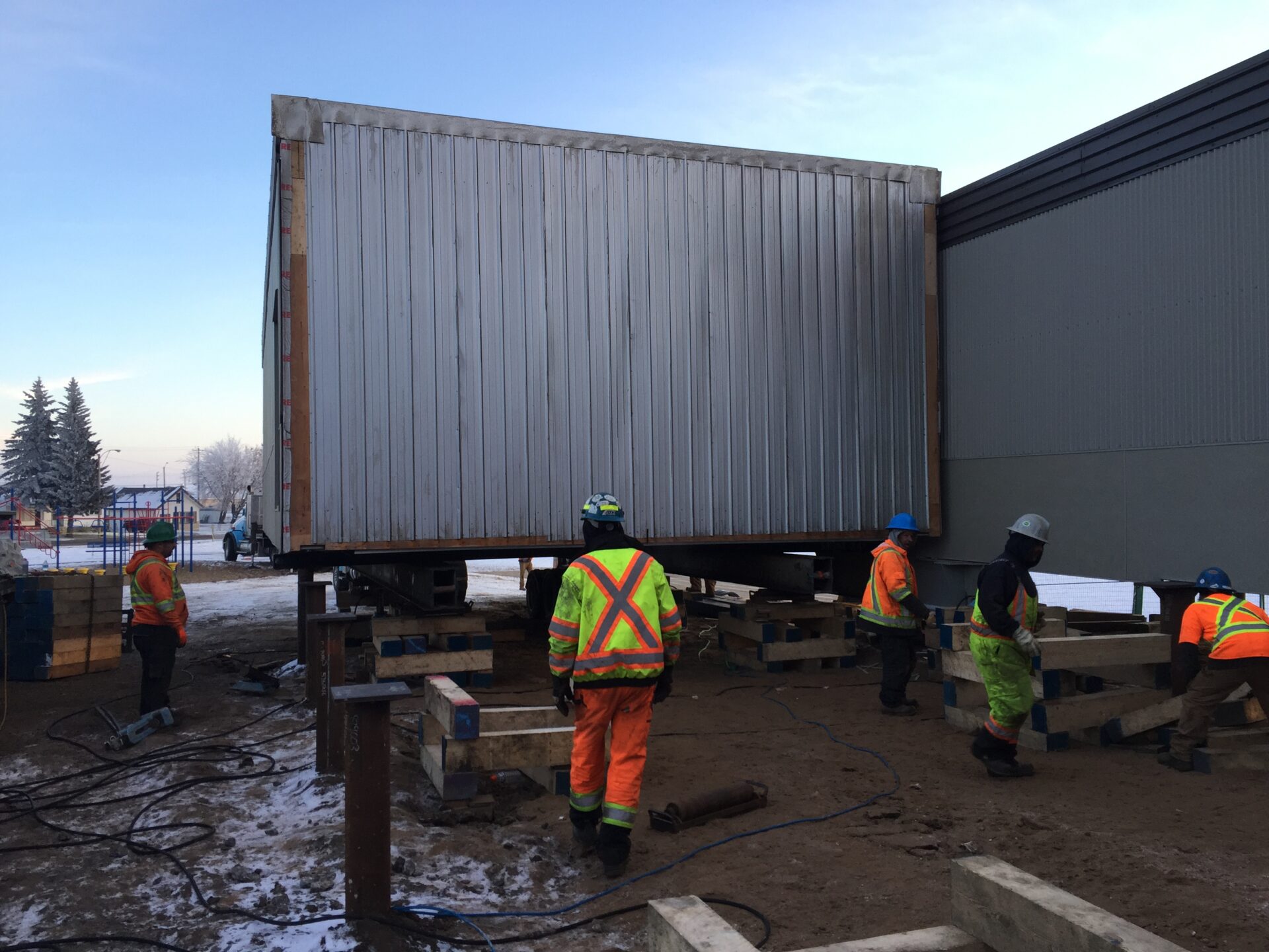Blessed Sacrament School Classroom Additions Constructio Construction workers on lift wearing safety equipment
